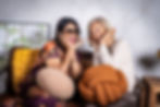Two middle aged women on sofa smiling