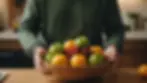 Close-up view of a person holding a fruit bowl