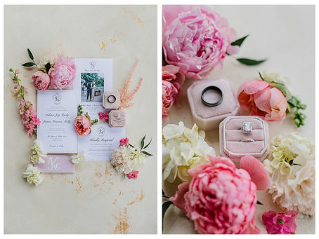 A flatlay of a wedding invitation suite and wedding rings