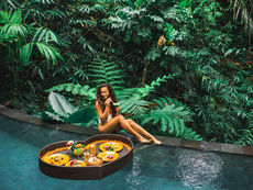 woman sitting on the edge of the pool