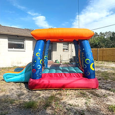 The "My 1st Jump n Play" Bounce House, which has blue pillars, and orange top, and a red slide, complete with an orange, red, and teal slide. Duration is listed for either 4 or 8 hours, starting at $35 for a daily rate.