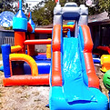 "The Castle" inflatable bounce house, featuring a ball pit, and 10ft slide!