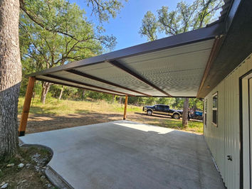 A brown metal covered patio in Waco, Texas, featuring a modern steel roof and durable steel framing, ideal for outdoor gatherings and protection from the elements.
