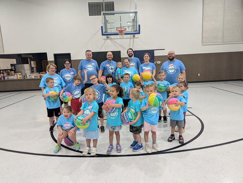 Basketball camp group photo kids and adults holding multicolored basketballs, Cedar Rapids, Good Shepherd
