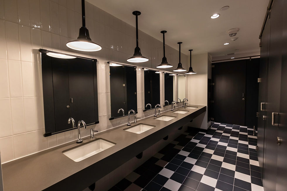 High angle view of a spacious, well-lit accessible restroom with grab bars and wide doorways