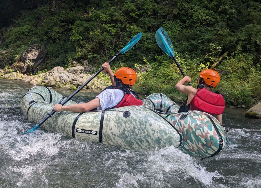 Guest enjoying Pack Raft on clear river water