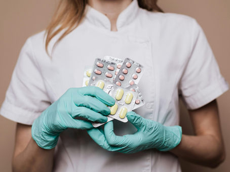 A female clinical pharmacist holding tablets