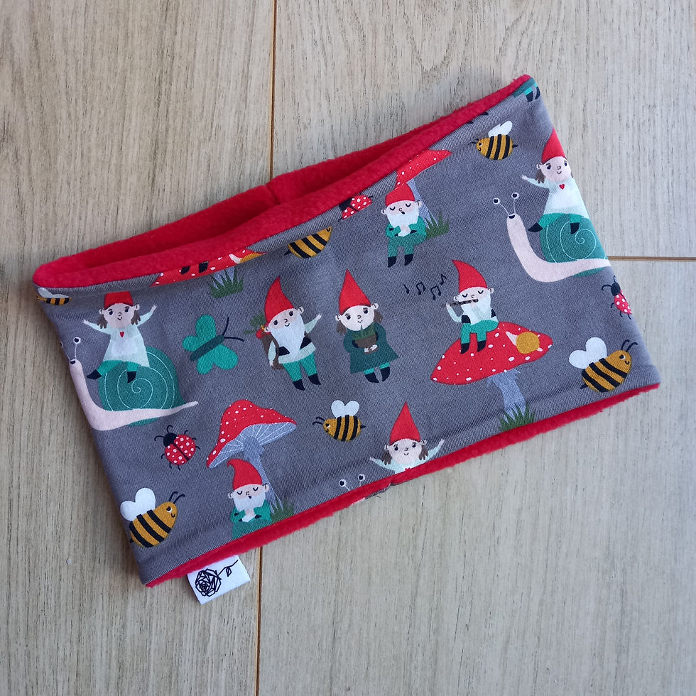 flat lay photo of childs gnomes and snail fleece lined snood