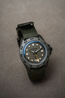 black watch with green fabric strap
