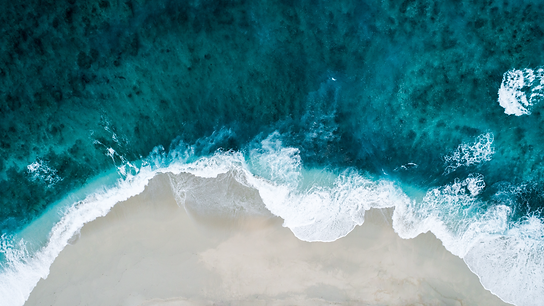 image of a beach with dark blue waters