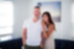 Smiling couple, Michael Kurland in white shirt, Alexandra Kurland in floral dress, White Glove Transportation OC
