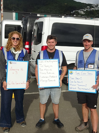 Guides waiting with signboards and blue hi vis.JPG
