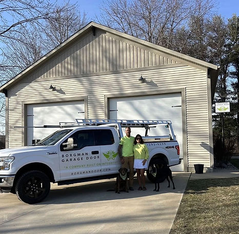 Edelman Garage Door team and service truck in front of a garage