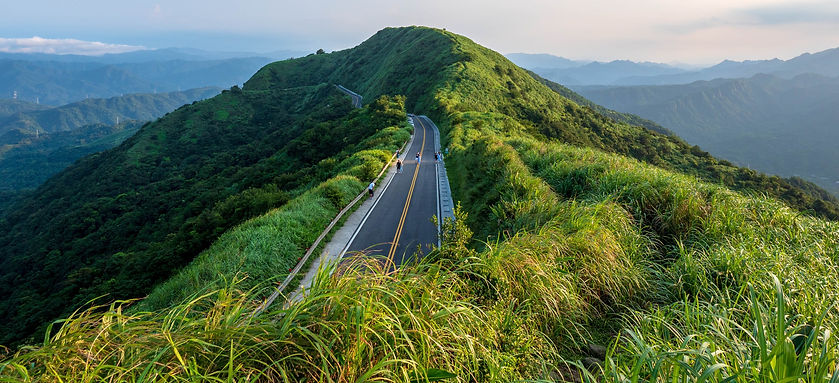 Panoramic view from Buyan Pavilion in Jiufen area, showcasing a scenic road surrounded by lush green mountains