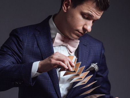 Magician performing a card flourish during a close-up magic show in New York City