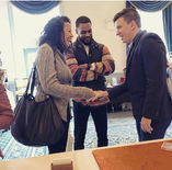 Magician interacting with guests during a close-up magic performance at an event