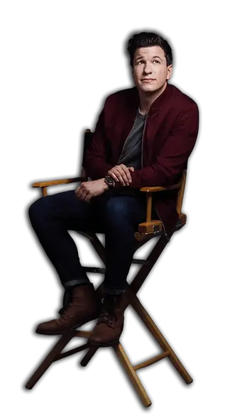 A portrait of Matt Szat seated on a chair, wearing a smart casual outfit, giving a friendly and approachable yet professional impression.