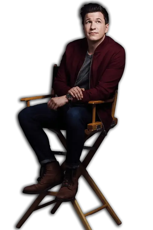 A portrait of Matt Szat seated on a chair, wearing a smart casual outfit, giving a friendly and approachable yet professional impression.