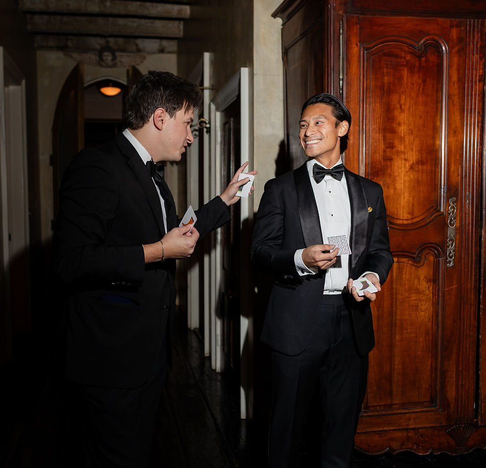Wedding magician entertaining guests with close-up magic during cocktail hour