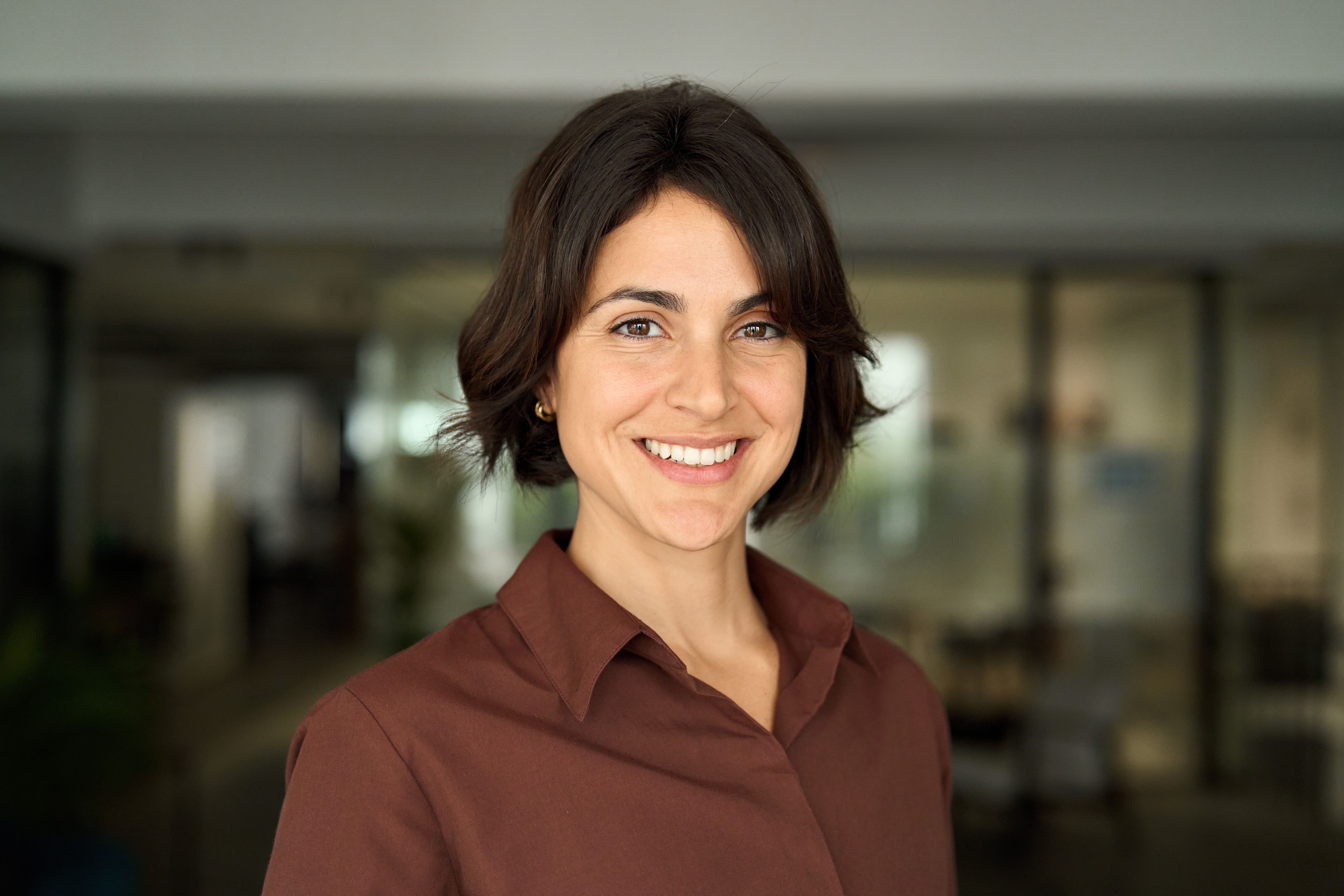 Headshot close up face portrait of young happy smiling Hispanic businesswoman, female comp