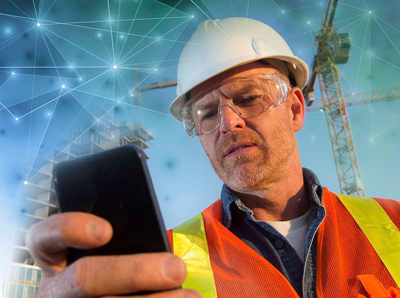 A worker in the field accessing GPS enabled training from the PinPoint app on his mobile device.
