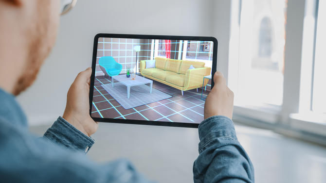 A user using augmented reality to envision new furniture in their apartment.