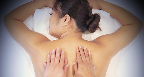 Four hands massage on a client's back for relaxation and wellness. Four Hands Massage to learn more.