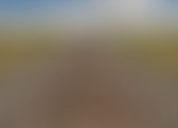 Straight railroad tracks stretch into the horizon, surrounded by desert foliage under a partly cloudy sky. A tranquil, endless journey vibe.