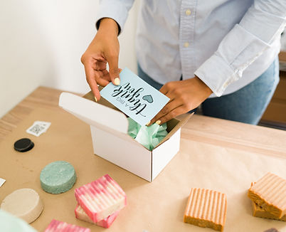 close-up-female-entrepreneur-packing-thank-you-note-customer-s-order-before-shipping-her-n