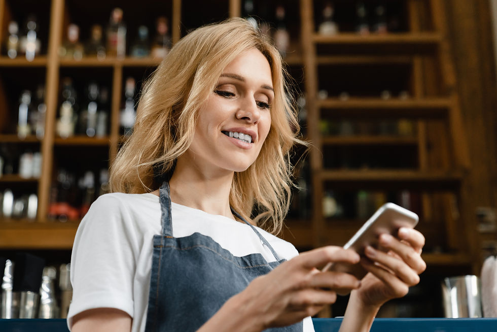 hospitality worker checking her phone