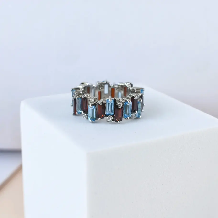 Garnet Blue topaz ring on white background on box