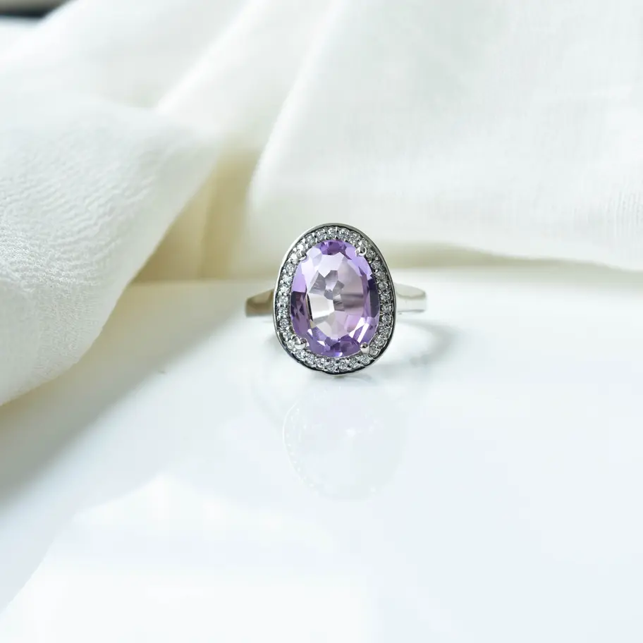 Oval natural amethyst ring in 925 sterling silver with halo setting, worn on hand, elegant purple gemstone statement ring for