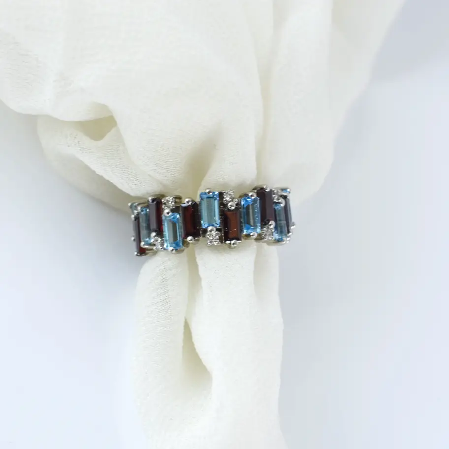 Garnet Blue topaz ring on white background in a cloth