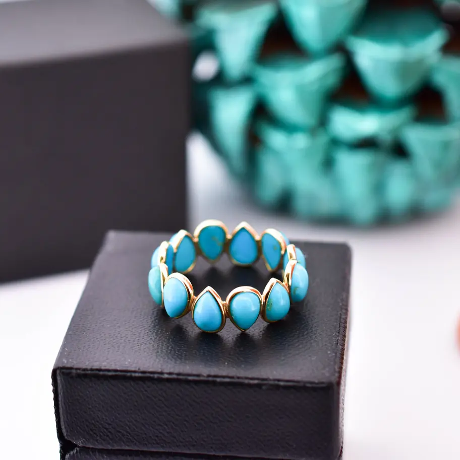 Fine jewellery eternity band featuring vibrant turquoise stones in 18K yellow gold