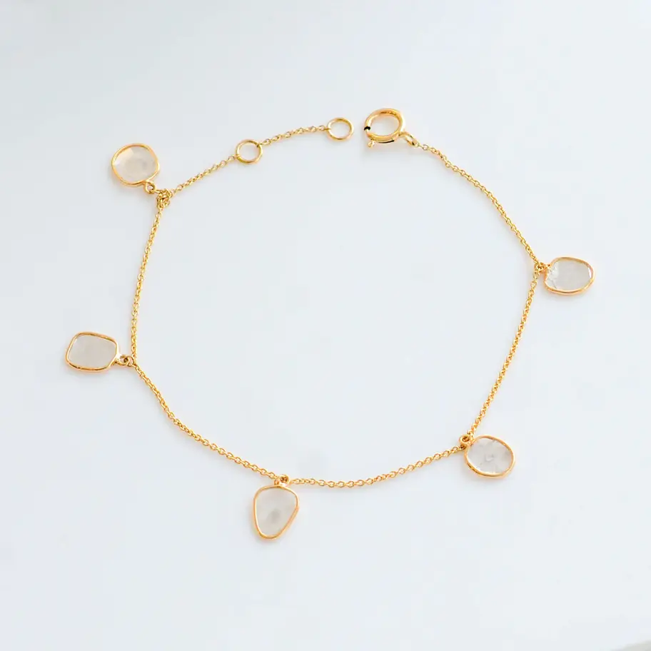 18K gold natural diamond bracelet with delicate teardrop bezel settings in a minimalist fine chain design