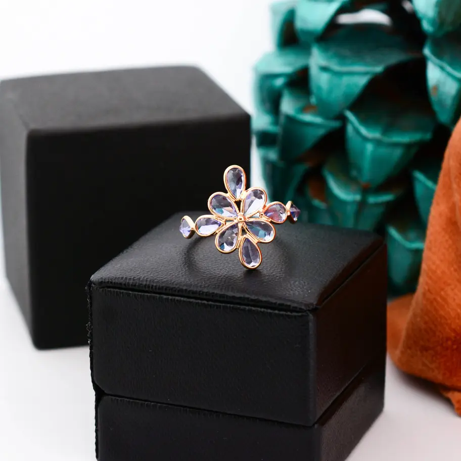 18K solid gold natural tanzanite flower ring with petal-shaped gemstones in an elegant floral cluster design
