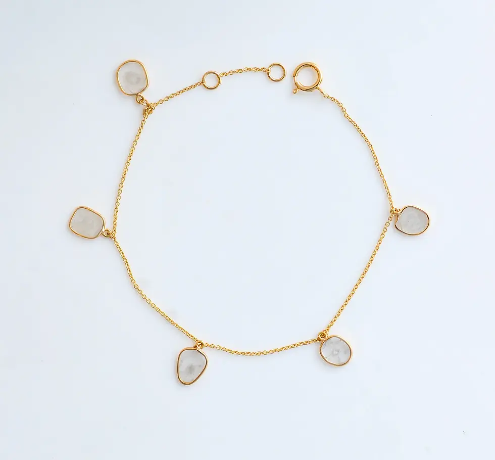 Lightweight 18K gold diamond bracelet featuring spaced teardrop diamond charms in elegant layout