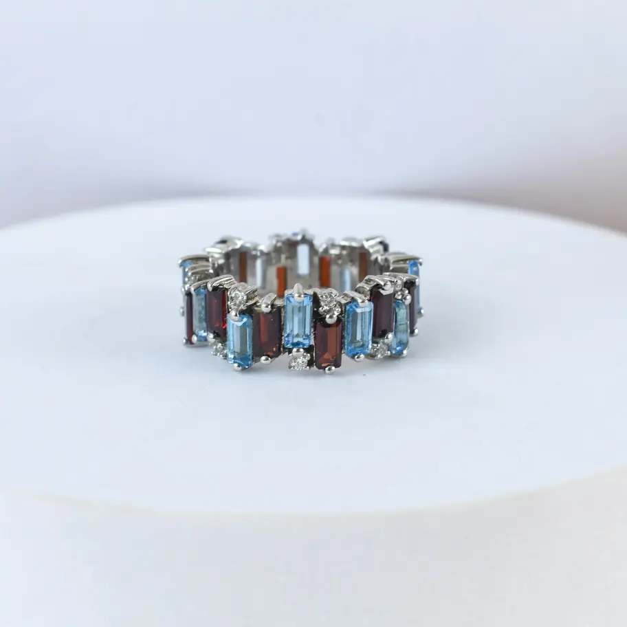 Garnet Blue topaz ring on white background
