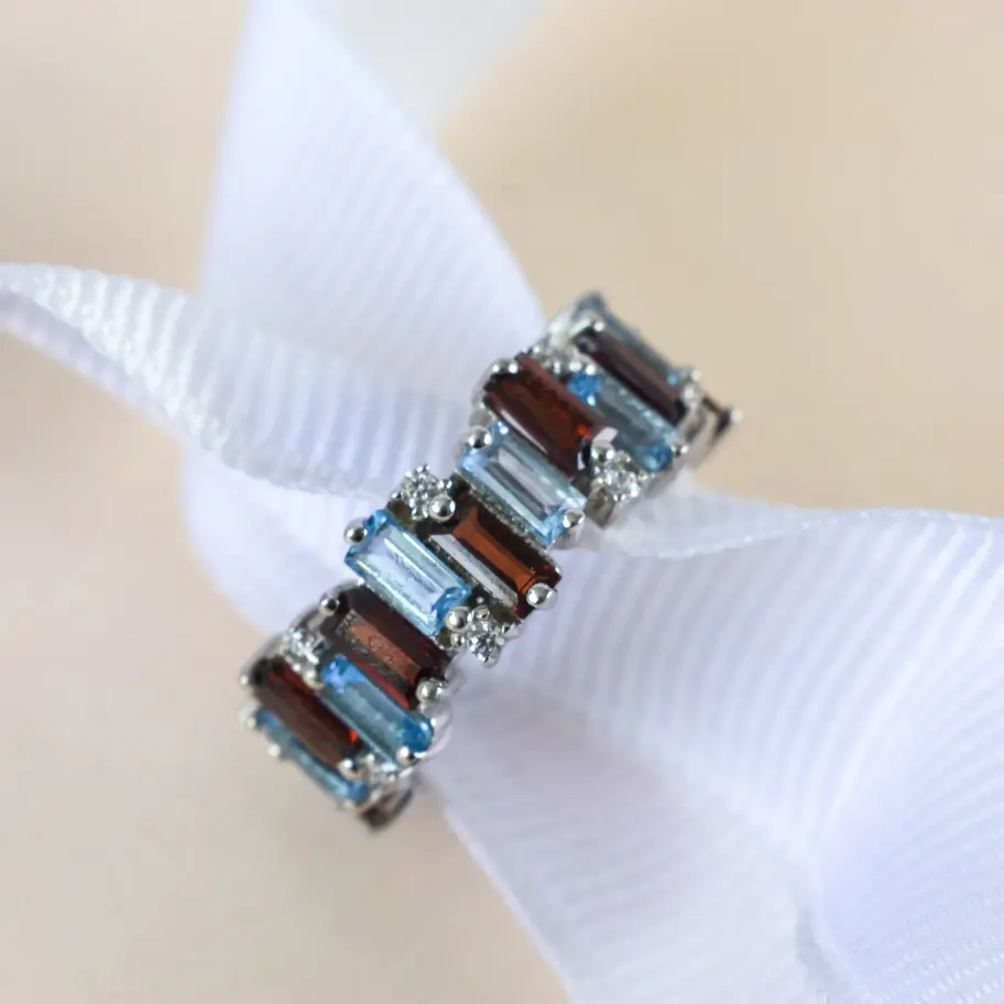 Garnet Blue topaz ring on white background