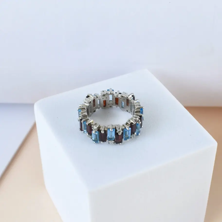 Garnet Blue topaz ring on white background
