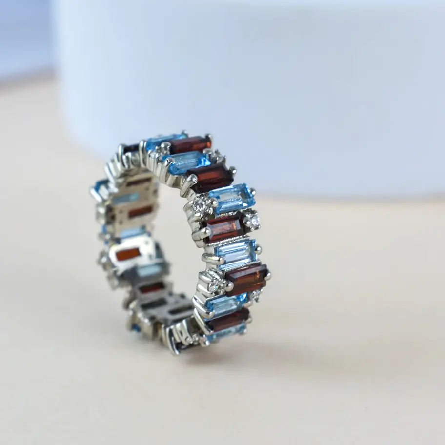 Garnet Blue topaz ring on white background