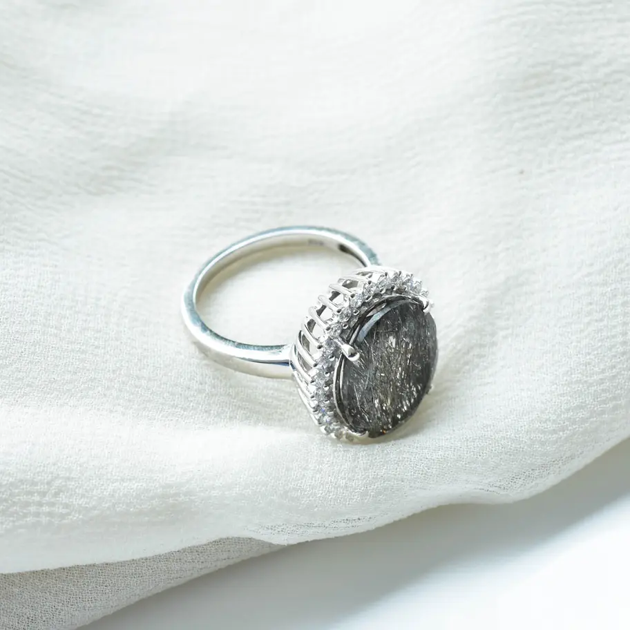 Textured black rutilated quartz gemstone ring with delicate silver halo, modern everyday jewellery