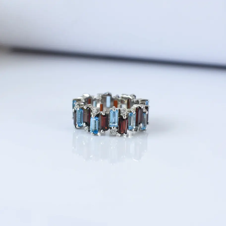 Garnet Blue topaz ring on white background