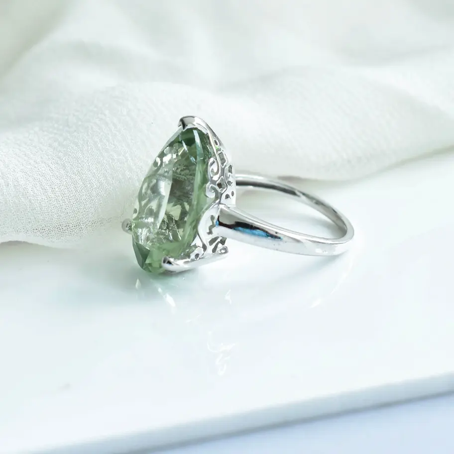 Side view of natural green amethyst ring showing elevated pear shaped gemstone on sleek 925 silver band