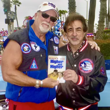 A photo of the book Higher and Higher with Dr. Leonard and a supporter.