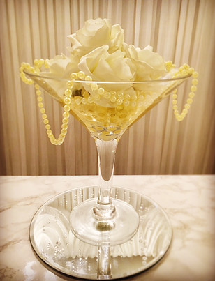 Cocktail vase centre piece decorated with gold water beads, ivory foam roses & pearl drapes