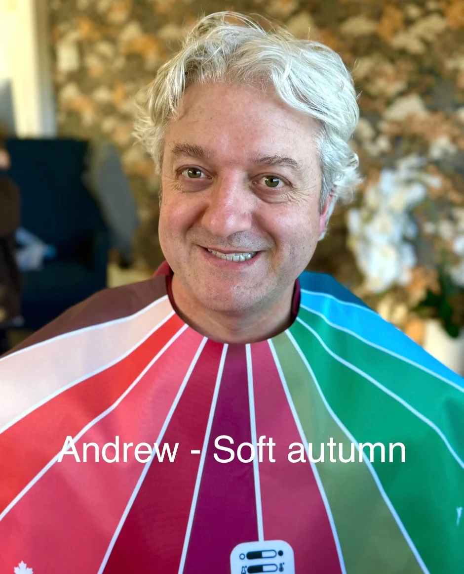 Stephanie Rumble’s happy client Andrew smiles during a colour analysis session, wearing a Soft Autumn drape to reveal her best shades.