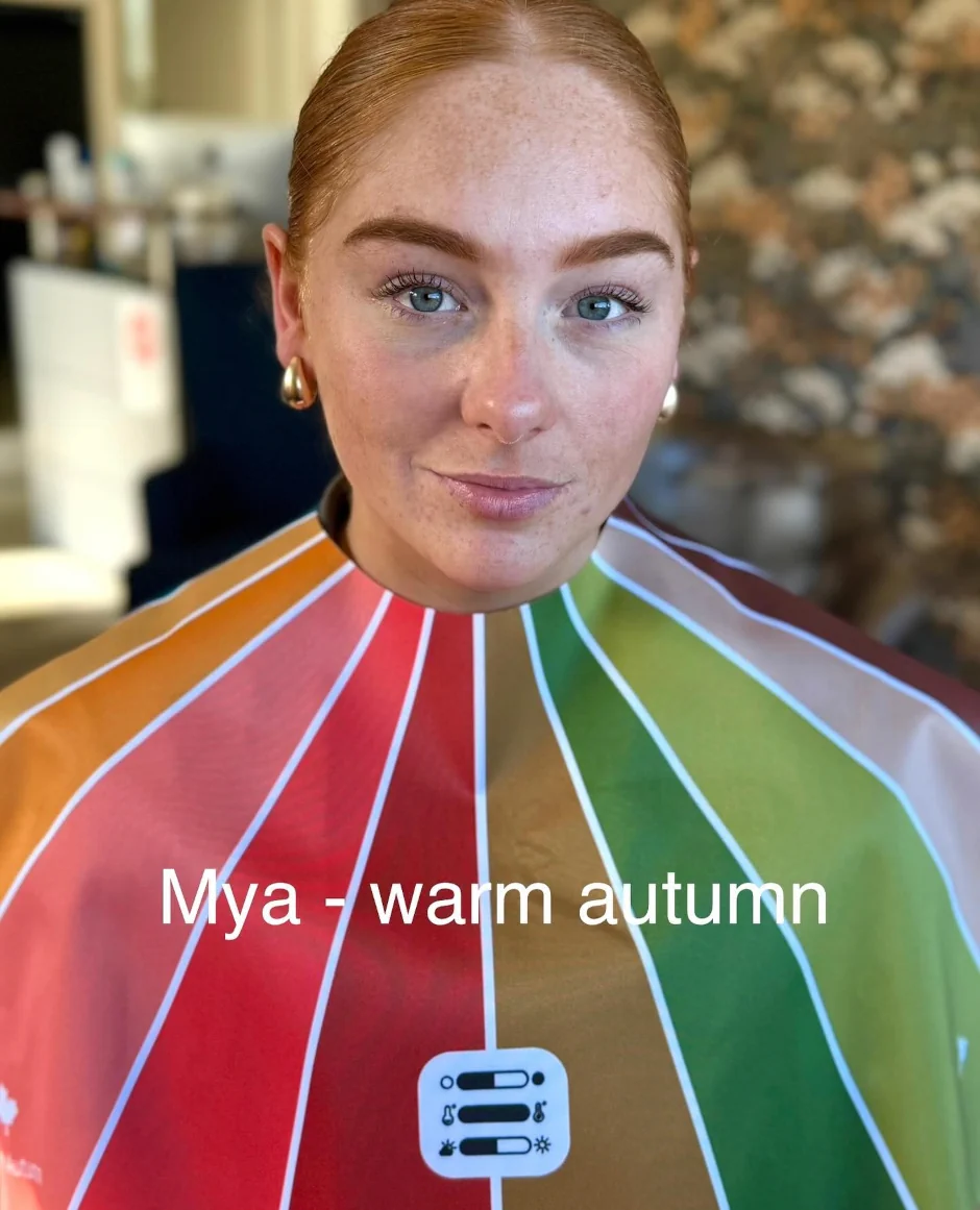 Stephanie Rumble’s happy client Mya smiles during a colour analysis session, wearing a Warm Autumn drape to reveal her best shades.