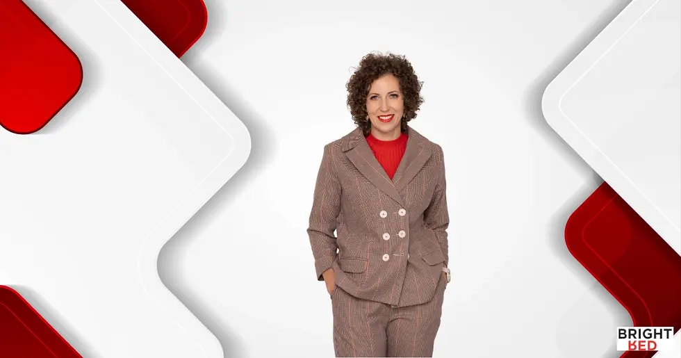 Stephanie Rumble, founder of Bright Red, stands confidently in a checked suit against a clean white and red geometric background.
