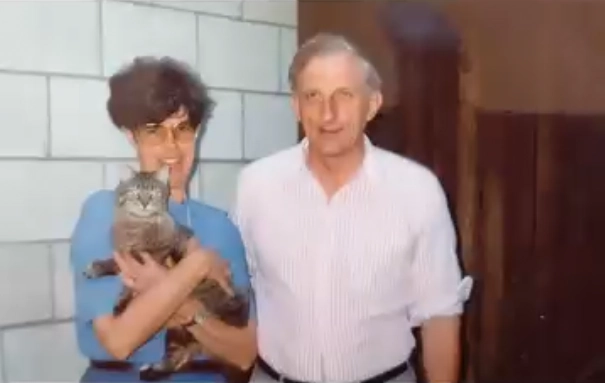 Stephanie’s parents smiling together, with her mother holding a cat, capturing a warm and candid family memory.